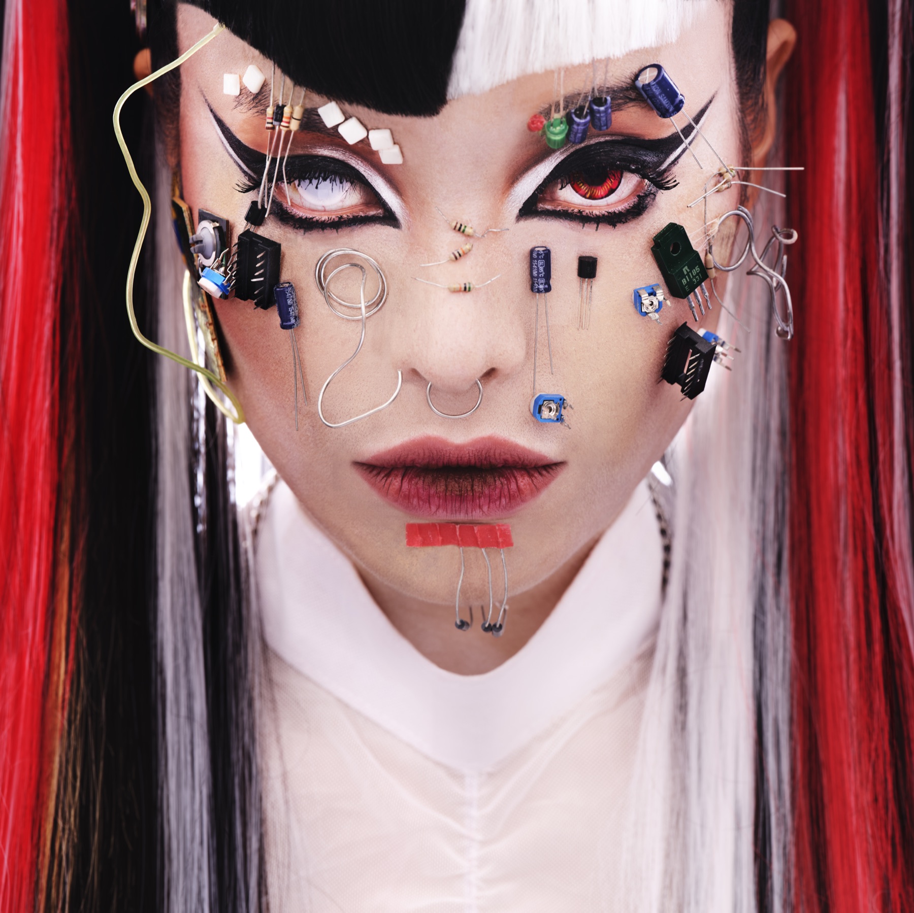 Close portrait of Pyra with electronic components applied across her face
