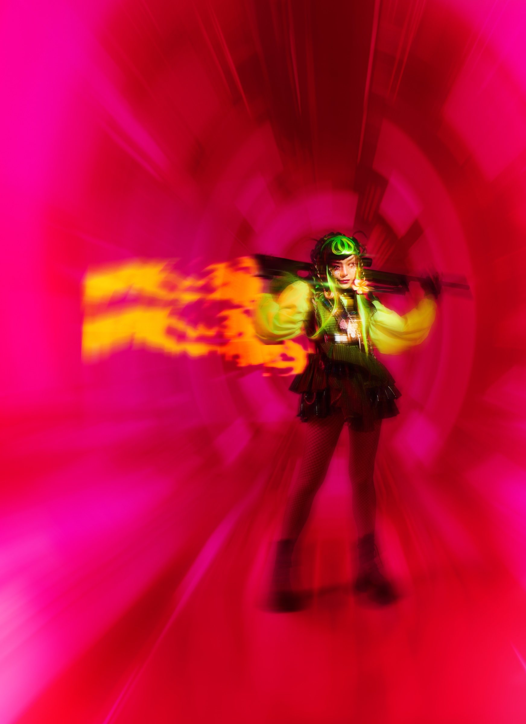 Full-body press photo of Pyra, Thai artist Peeralada Sukawat, against a vivid pink background